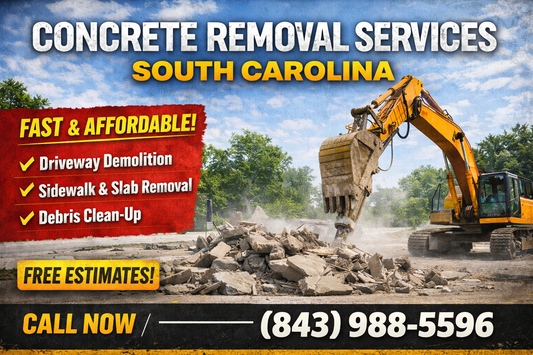 Excavator breaking up concrete slab during removal service in South Carolina